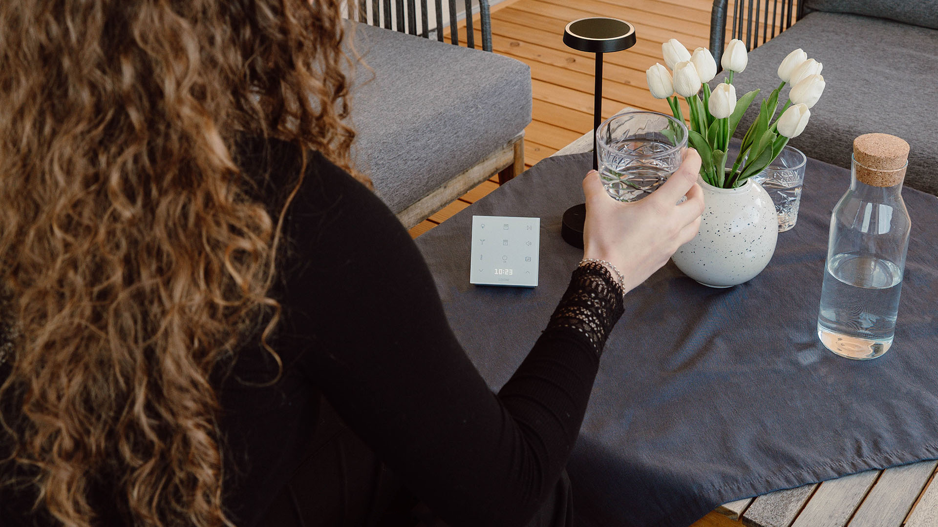 Woman on the patio, with a white Touch Pure Flex on the table
